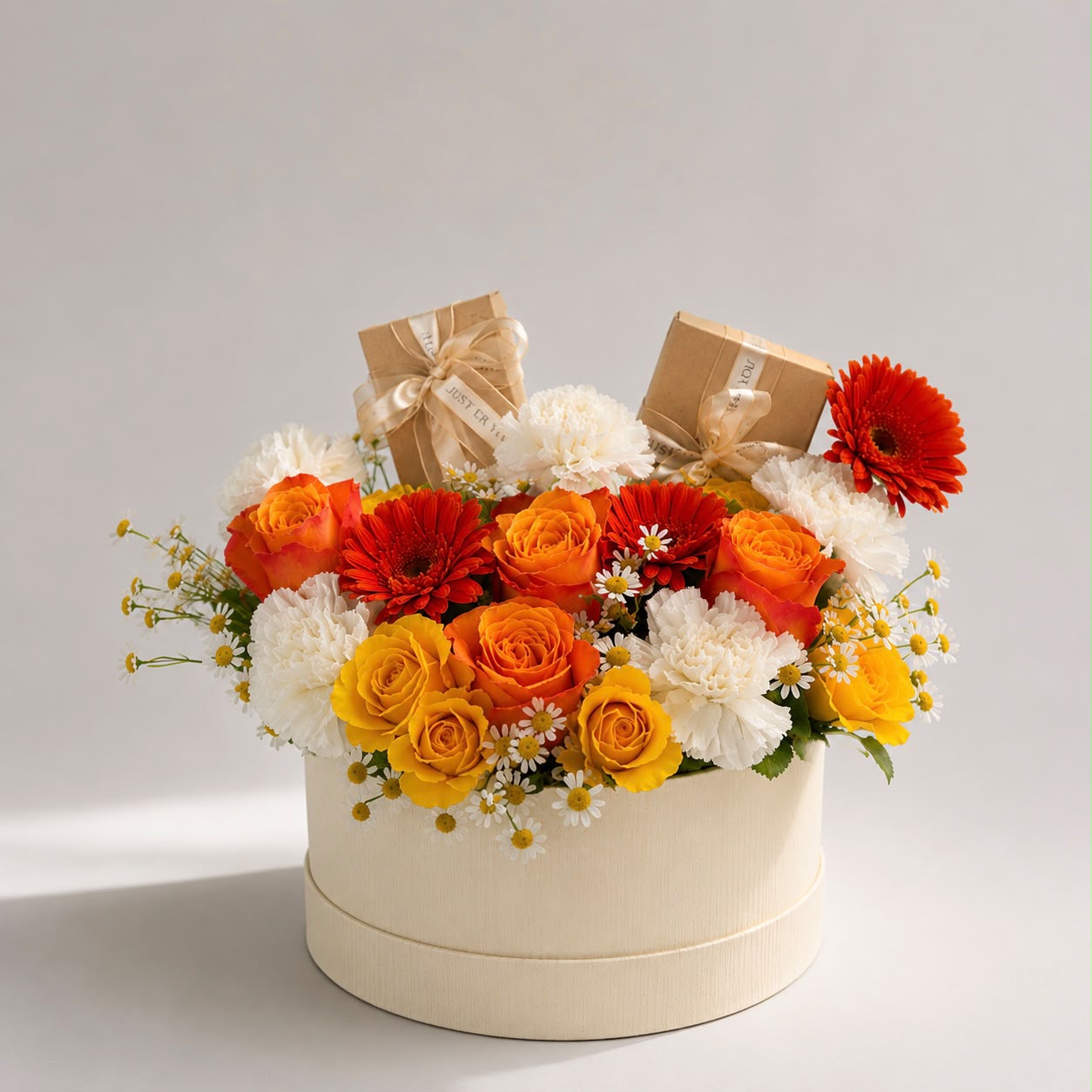 Sunny: orange and yellow rose, carnation, gerbera in a gift box