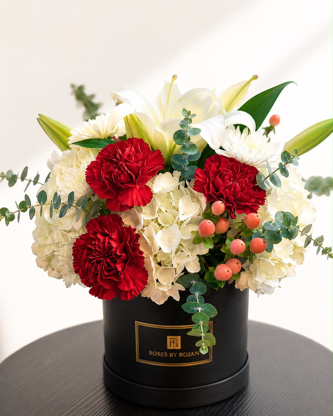 Passion: red carnation, chrysanthemum, hypericum in a gift box