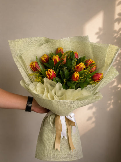 Golden Flame Tulip: red and yellow tulip, solidago in a bouquet